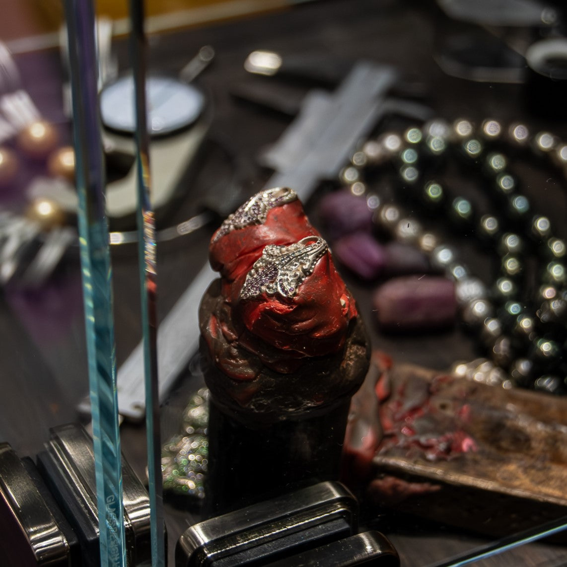 Jewellery Show 2023 display case exhibiting silver cufflinks partially set with fancy sapphires, highlighting craftsmanship
