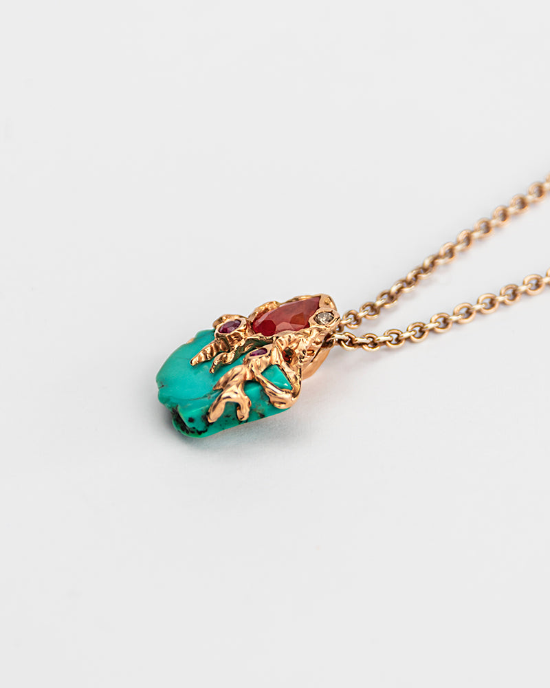 This pendant from the Lava collection is a unique piece crafted from 18K Rose Gold and adorned with Turquoise, Orange Sapphire, Ruby, & Diamond