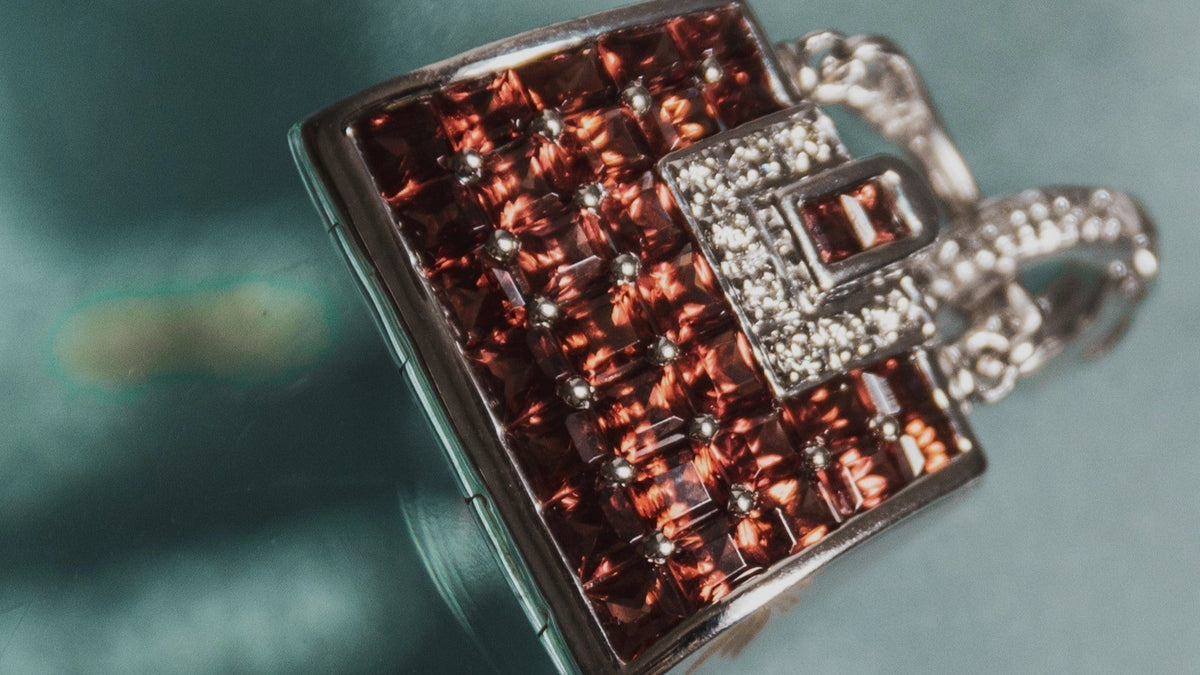 White gold, red garnet, and diamond pendant detail