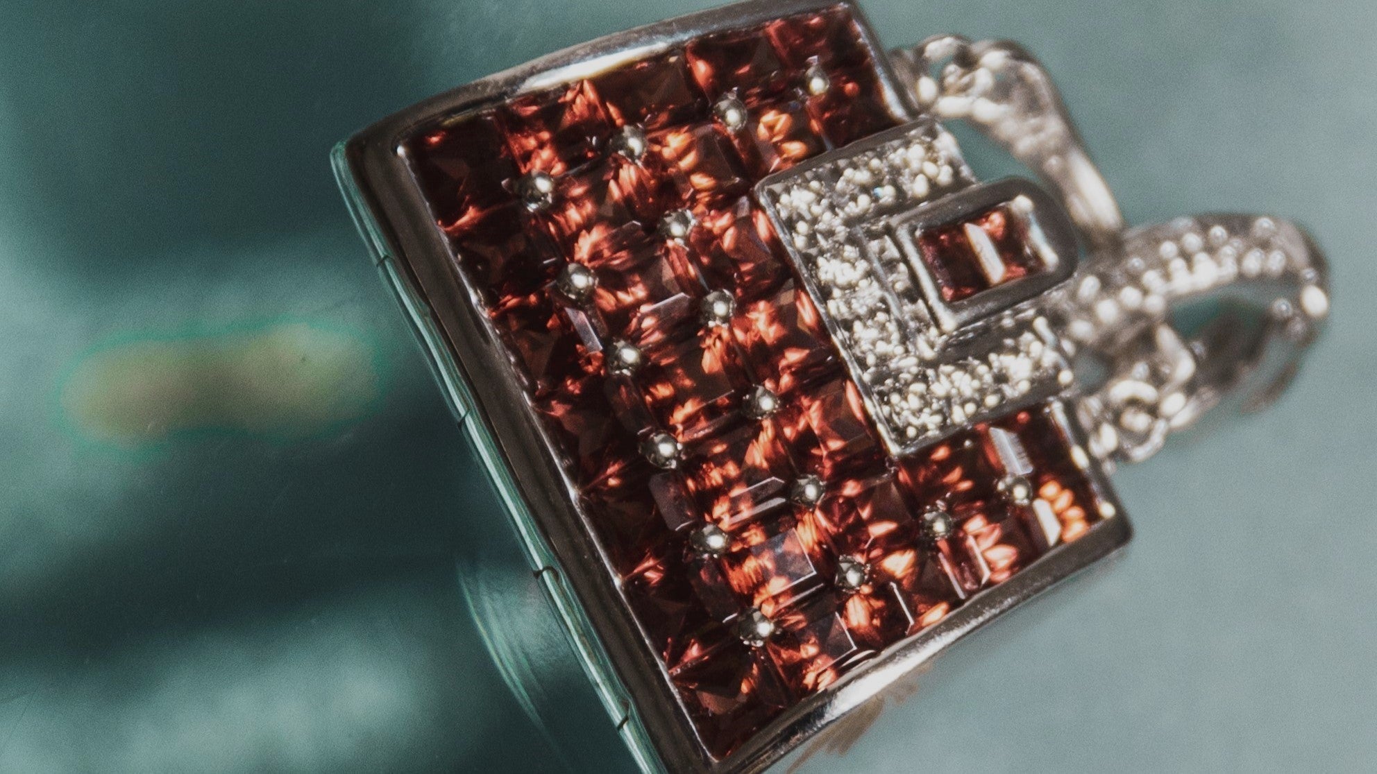 White gold, red garnet, and diamond pendant detail
