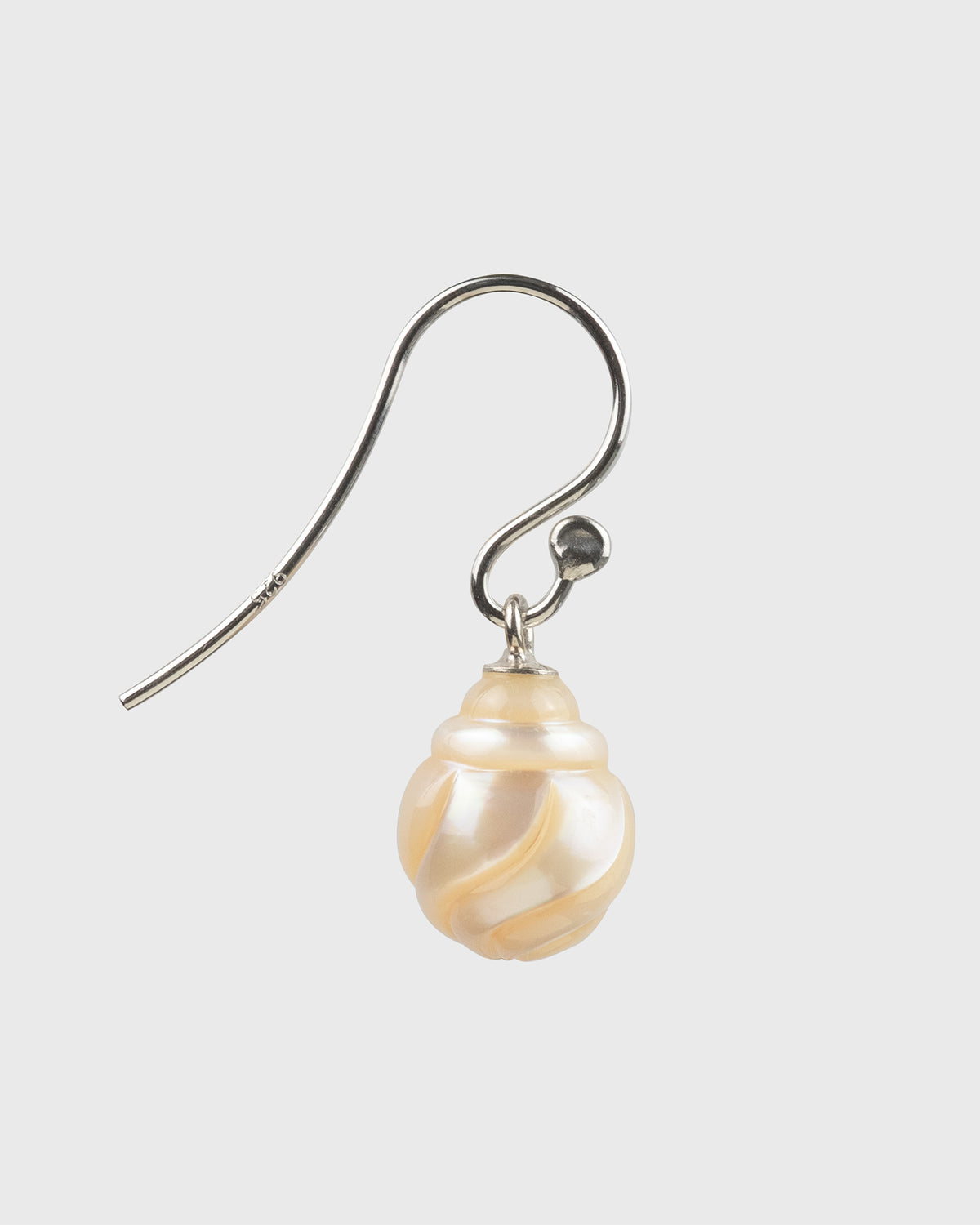 Pearl earring on a light gray background