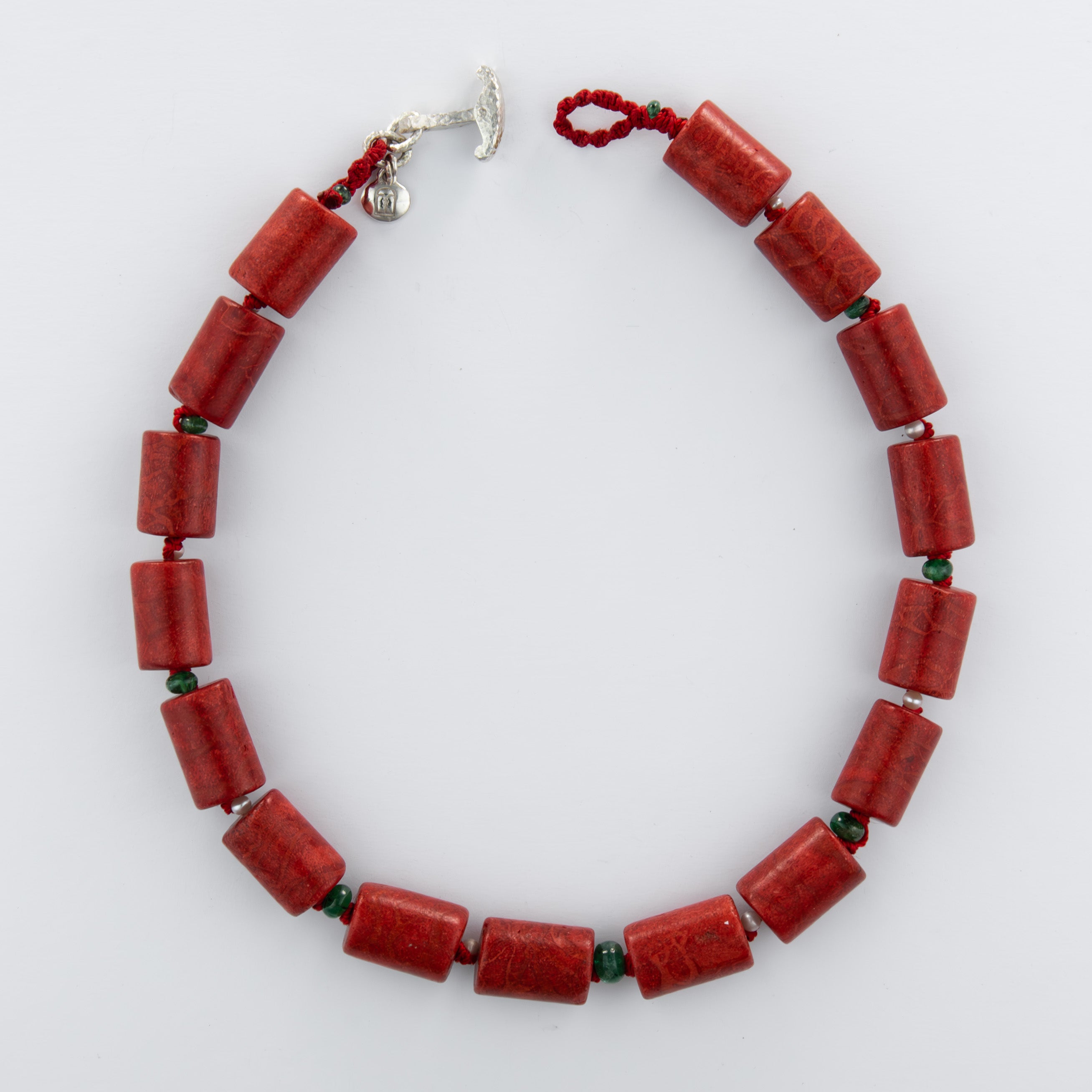 Red beaded necklace on a white background