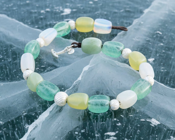 Necklace with green and white beads on a white background