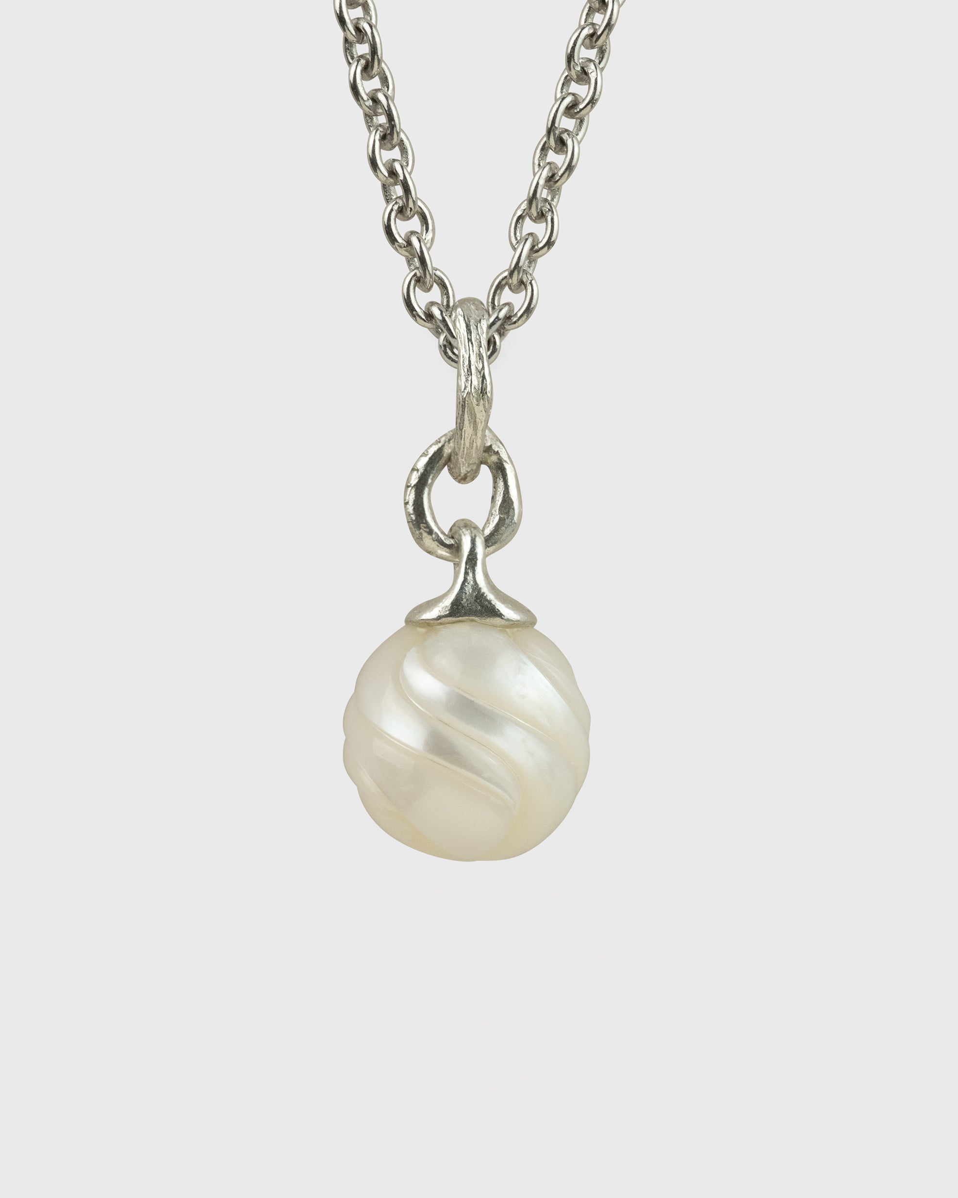 Pearl necklace with silver chain on a white background