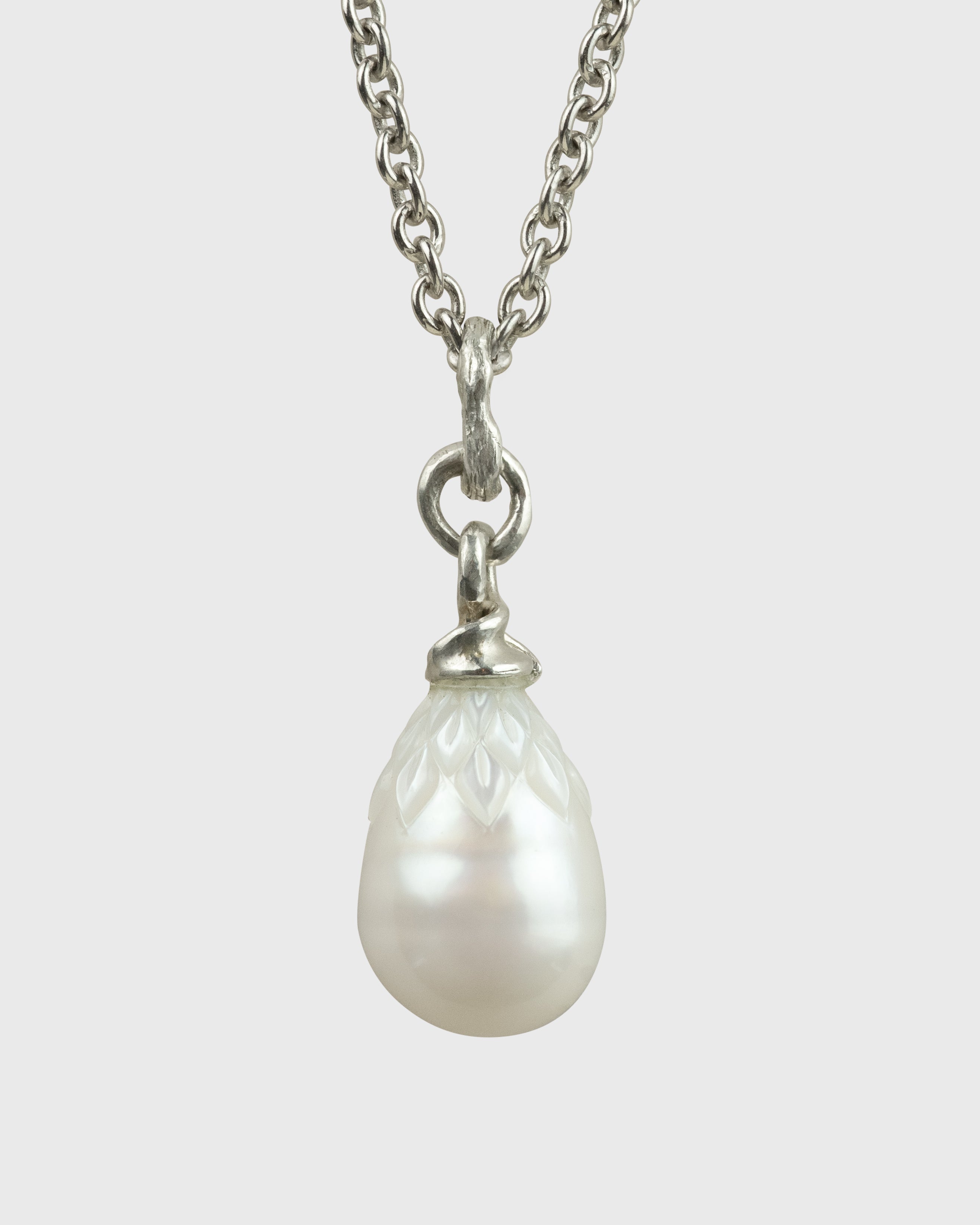 Pearl necklace with silver chain on a white background