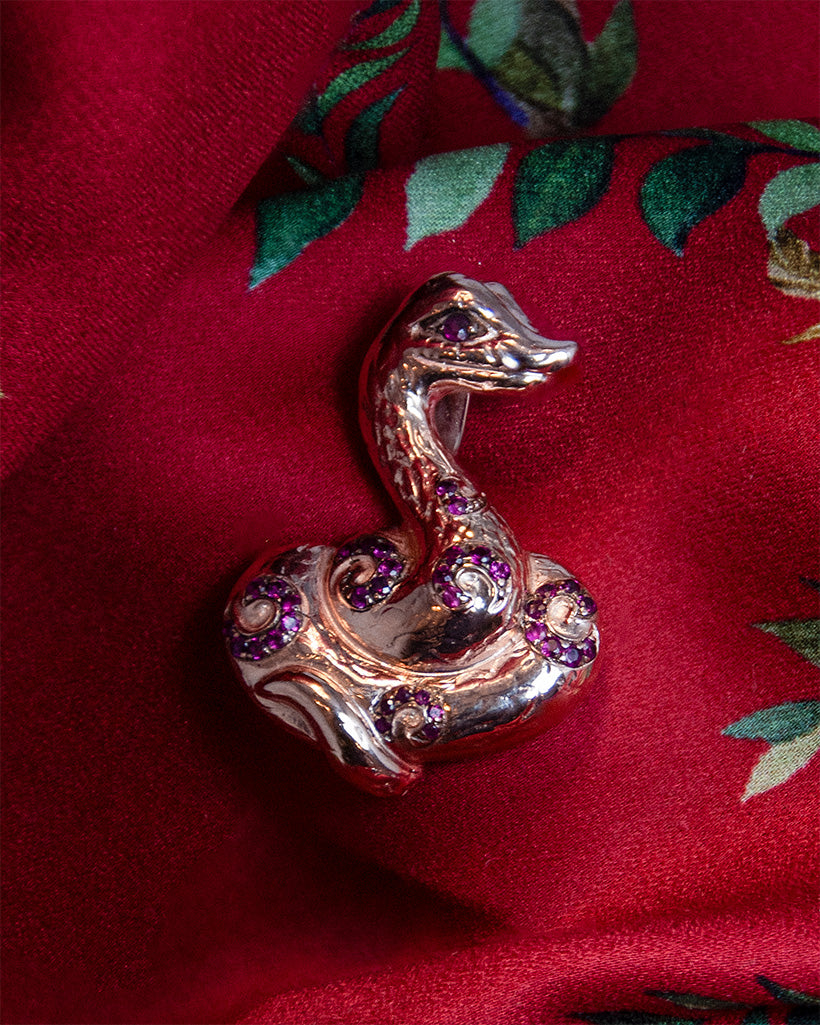 Pendant in the shape of a snake, featuring Rubies set in Sterling Silver plated with Rose Gold