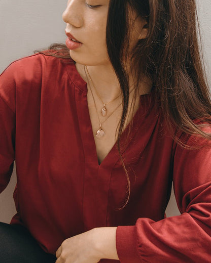 Katerina wearing layered Kara pendants