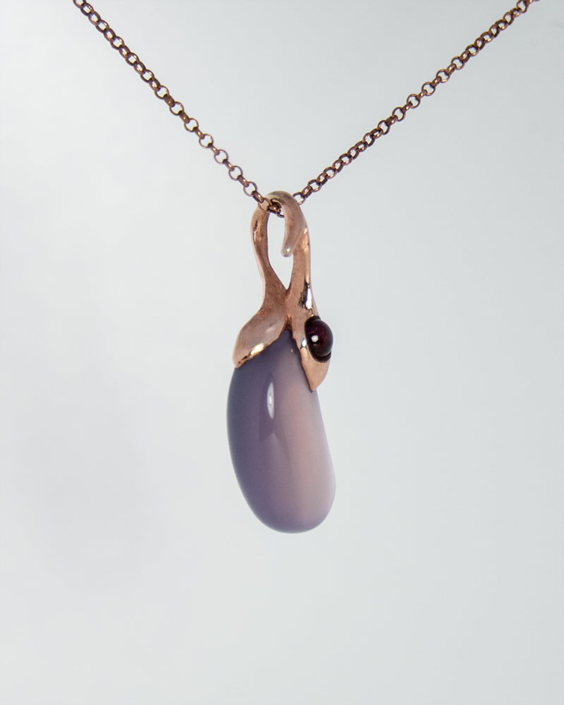 angled view of gold-plated silver pendant, revealing hand-textured detailing