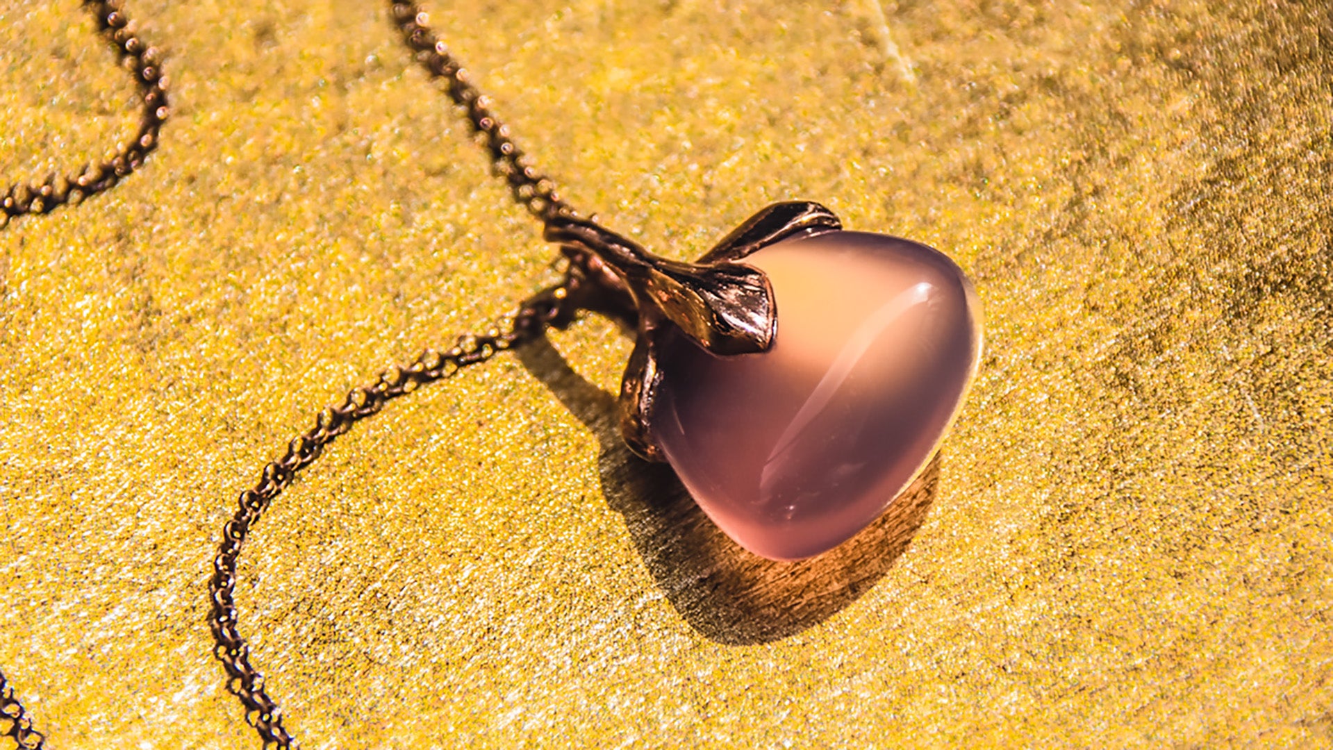 Kara unique 18K rose gold plated silver purple chalcedony pendant on a gold-coloured background