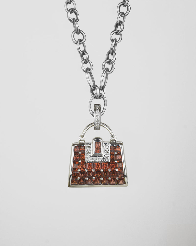 18K white gold locket pendant, featuring garnet and diamond in precise, handbag-shaped frame