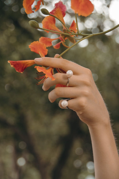 Model wearing Arched Metals black rhodium plated silver ring with handcrafted freshwater pearls