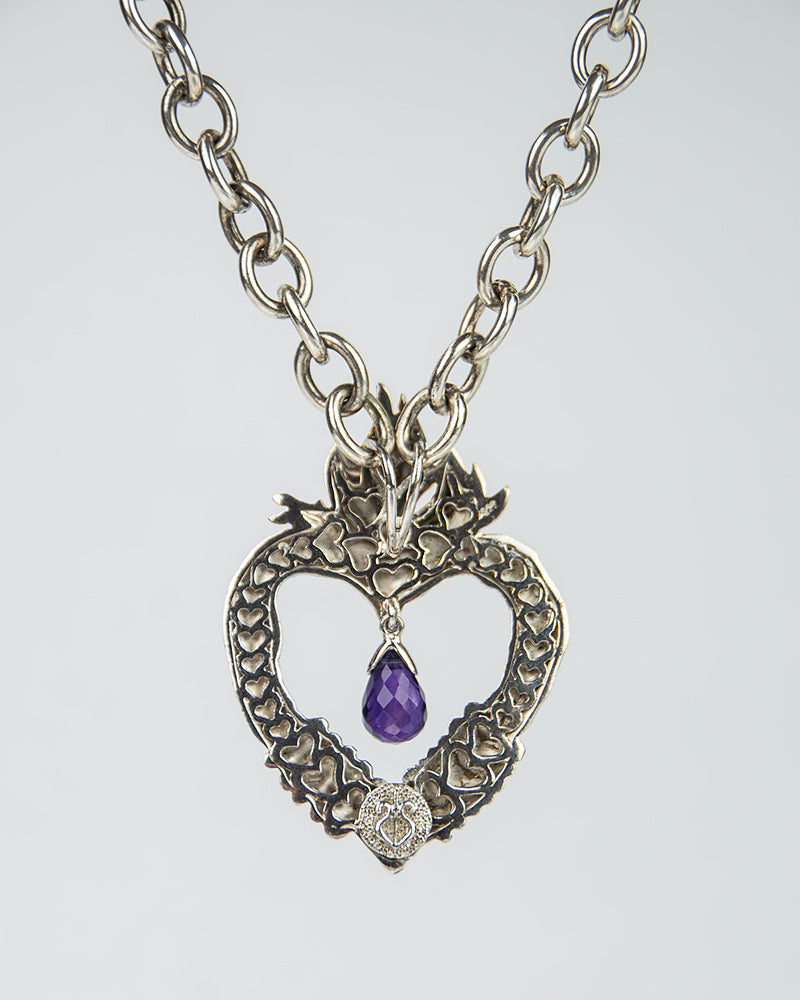 back of a heart-shaped silver pendant, showcasing its sentimental design 