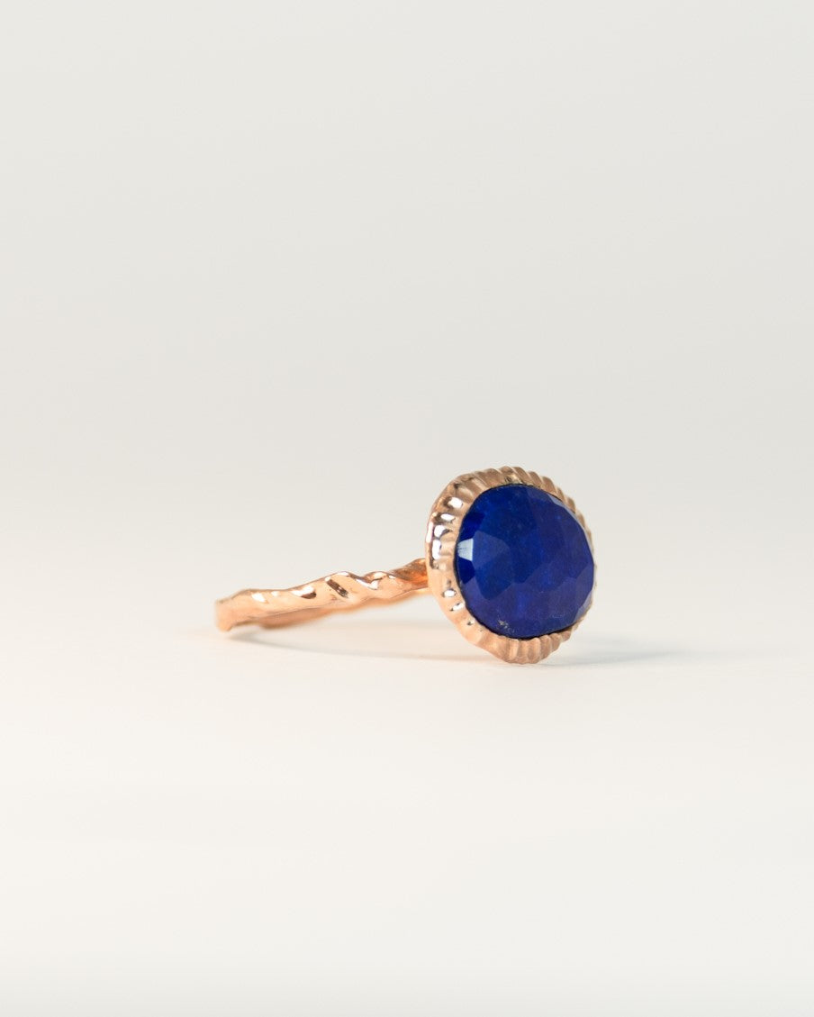 angled view of a gold-plated sterling silver ring, highlighting the artistic, free-form band