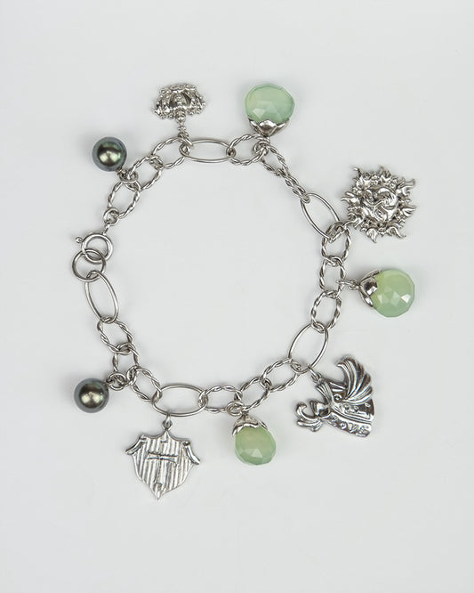 silver bracelet, featuring symbolic charms, black Tahitian pearls, and green chalcedony