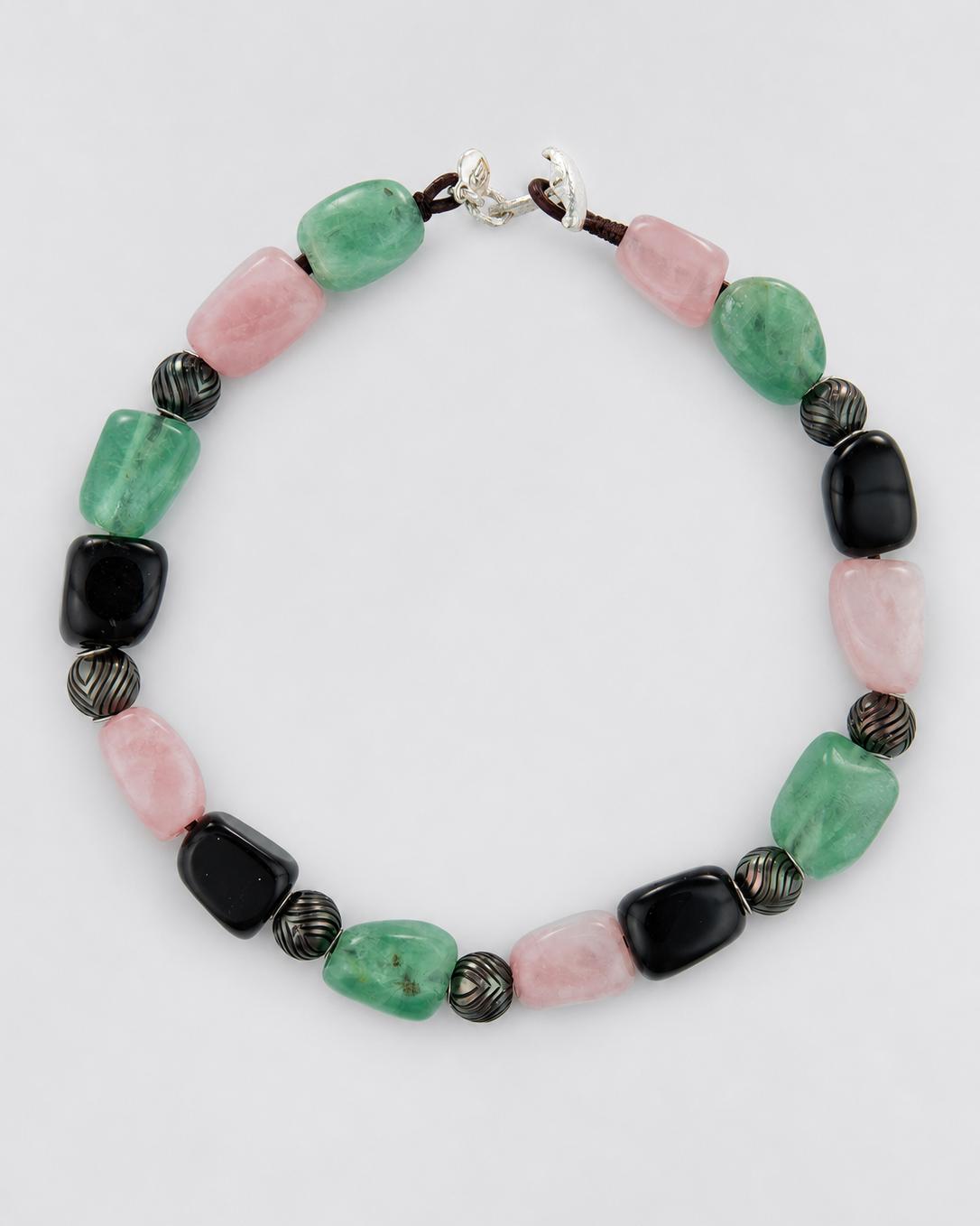 A beaded necklace featuring polished green, pink, and black beads, engraved black Tahitian pearls, with a silver clasp.