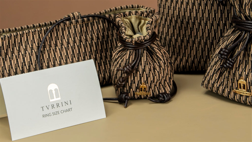 TVRRINI ring size chart card beside jewellery pouches