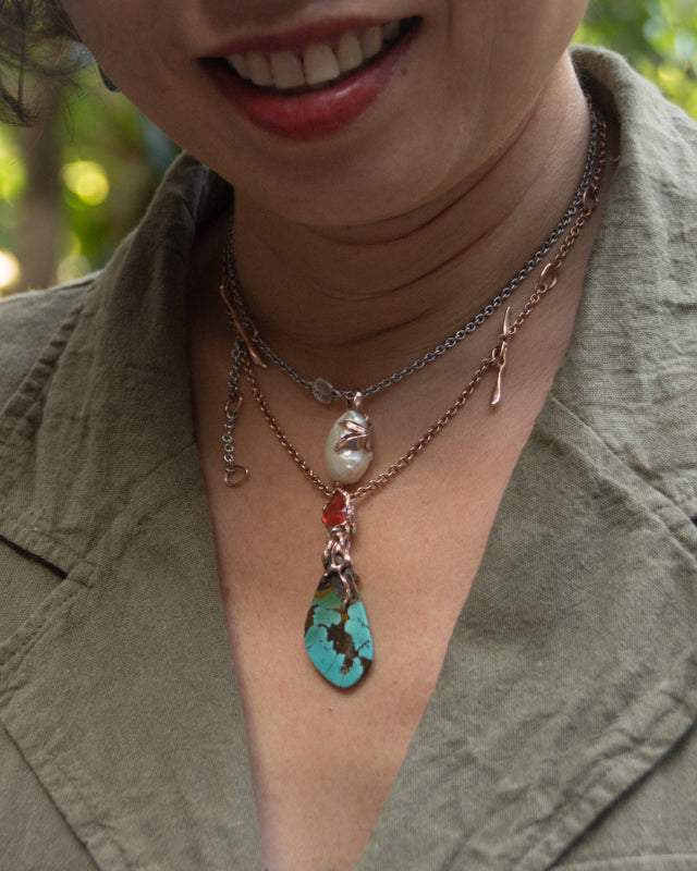 Outdoor shoot featuring layered necklaces designed by TVRRINI.