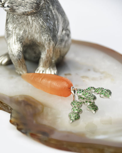 By design the carnelian carrot can be removed from the rabbit's paws