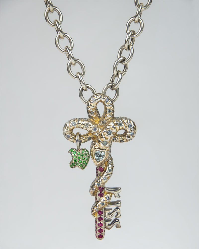 Sterling silver pendant in the shape of a snake entwined around a key with bitten apple charm, set with various coloured gemstones, on a silver chain