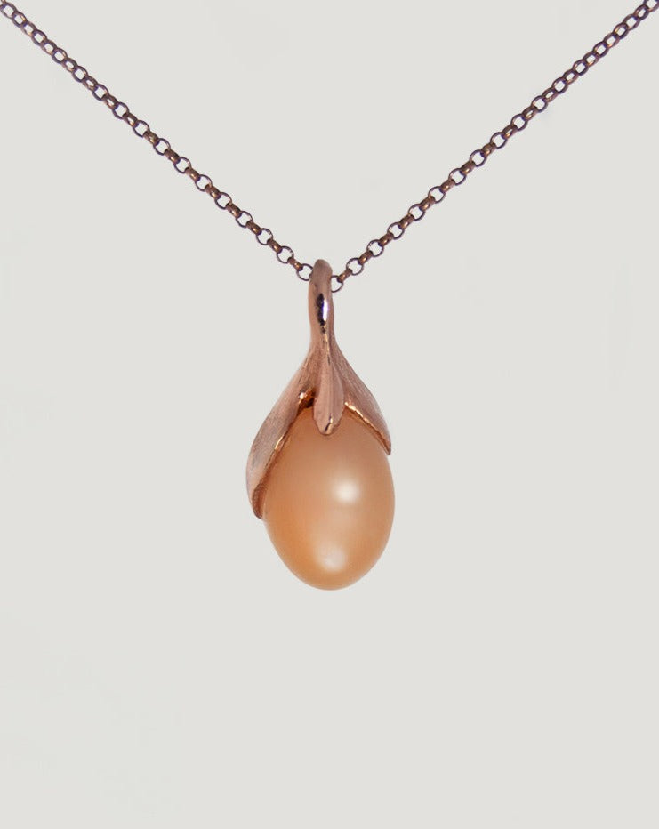 Front side of a unique Kara Pendant with Oval Cabochon Peach Moonstone, 18K Rose Gold-plated Silver