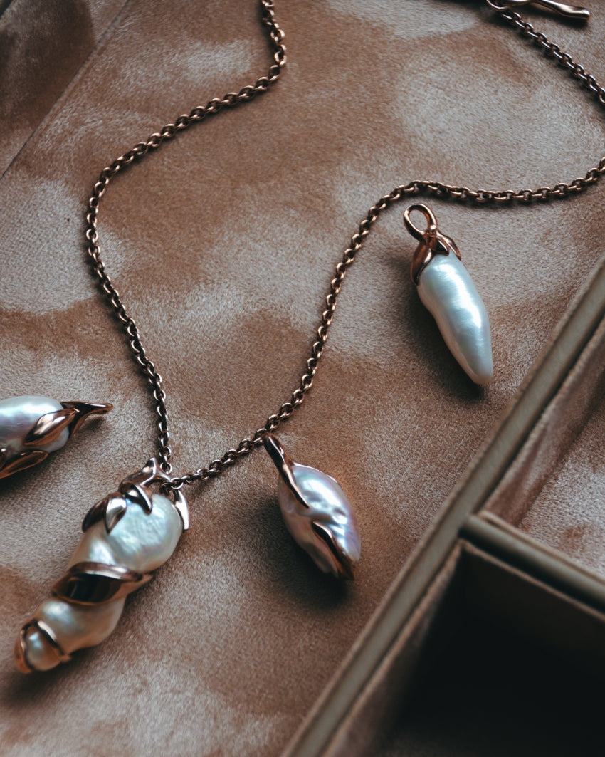 Unique baroque pearl pendants from the Kara collection displayed in a jewellery box