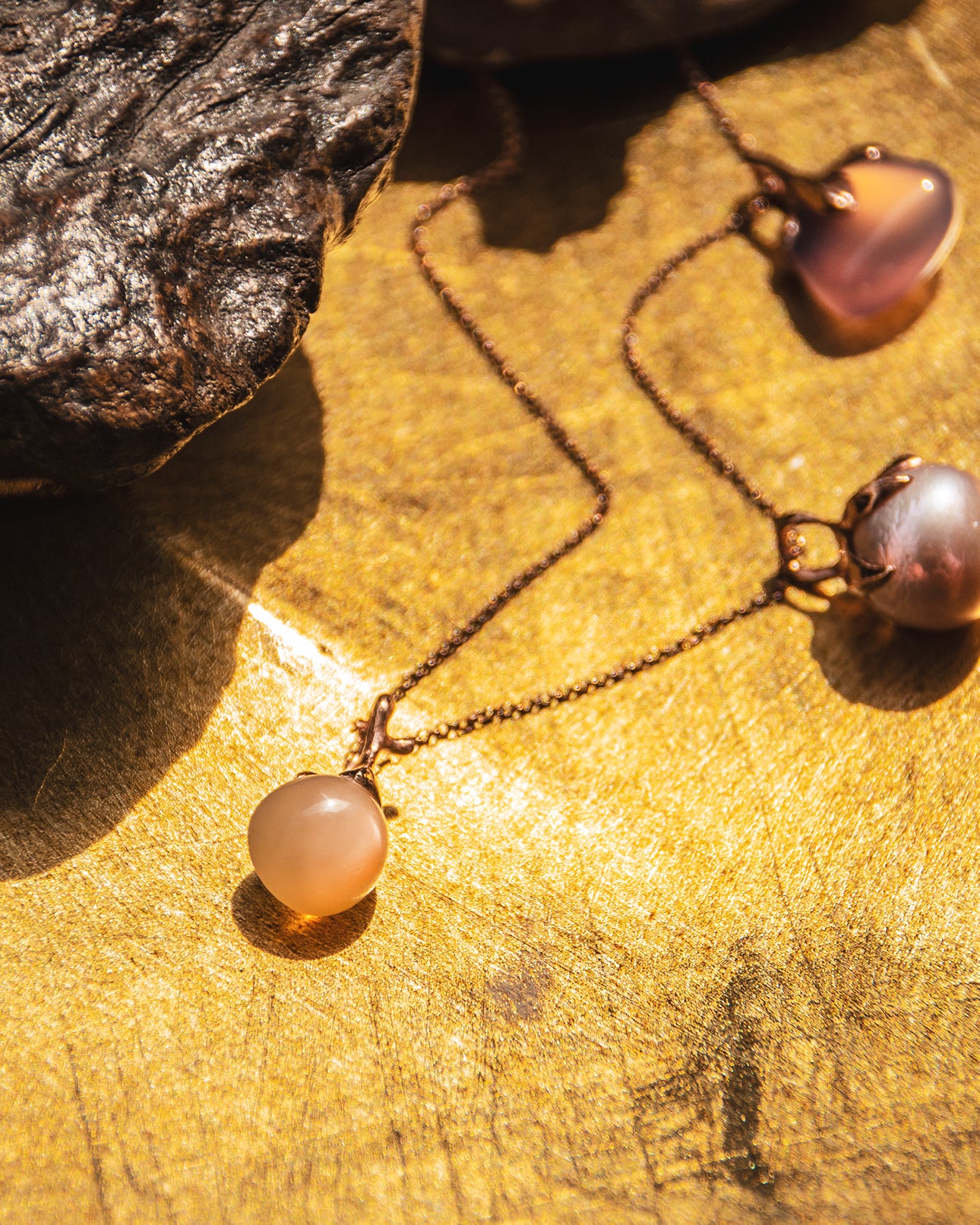 Editorial photograph of THP988RG Kara Pendant with Peach Moonstone set in 18K Rose Gold with other pendants