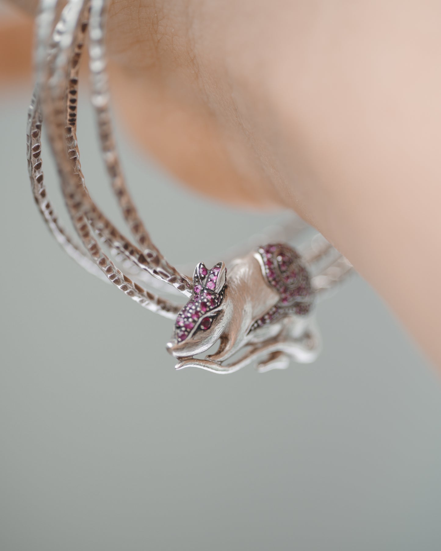 Circle of Life Rat Pendant created from silver and rubies, worn as a bracelet charm