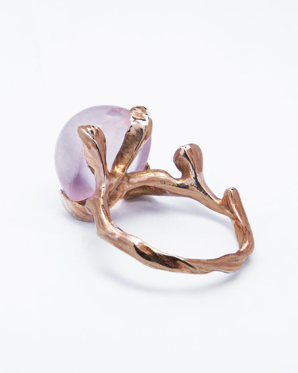 underside of a ring showcasing its sculpted, free-form design resembling leaves holding the central rose quartz