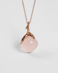 A sterling silver pendant with rose gold plating, featuring the organic setting on a rose quartz square cabochon
