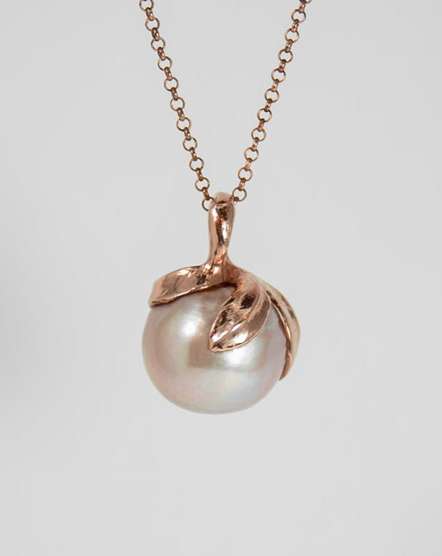 pendant featuring a luminous freshwater pearl set in a free-form sculpted sterling silver setting, exhibiting its modern design