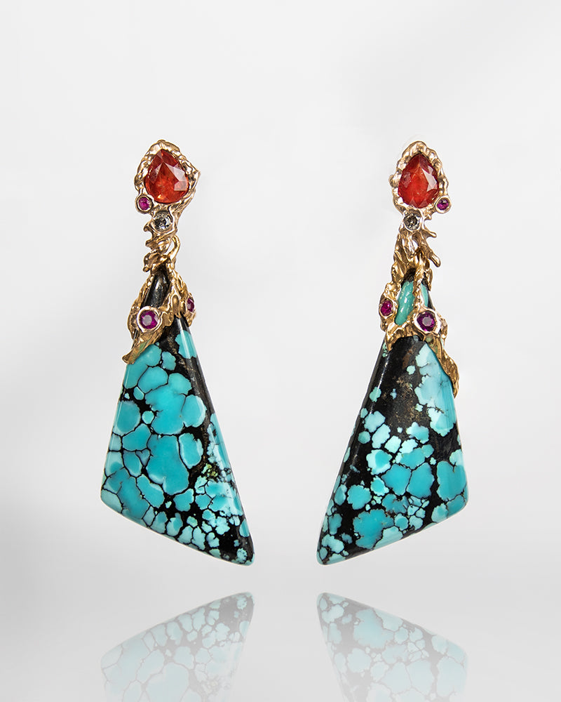 front view of detachable earrings featuring turquoise, orange sapphires, rubies, and diamonds set in a molten, abstract 18K gold setting