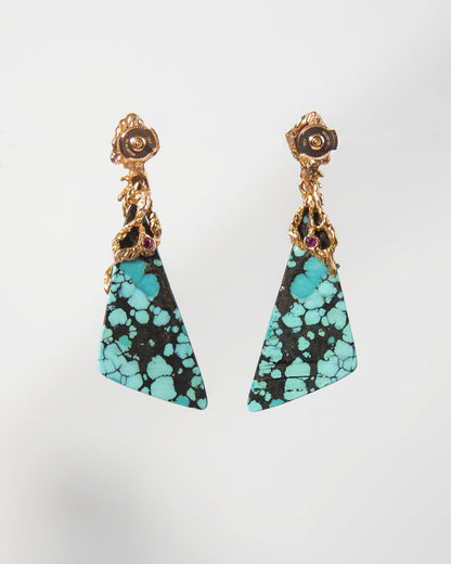 back view of earrings featuring sculpted gold setting on turquoise and rubies