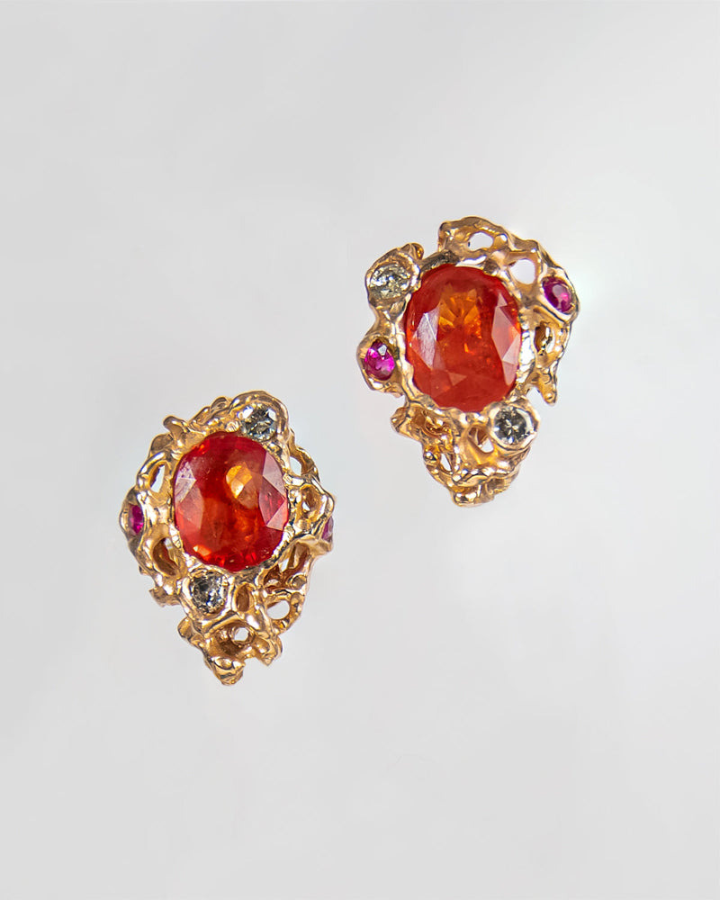 close-up of earring studs crafted from 18K Rose Gold set with Orange Sapphire, Ruby and Diamond