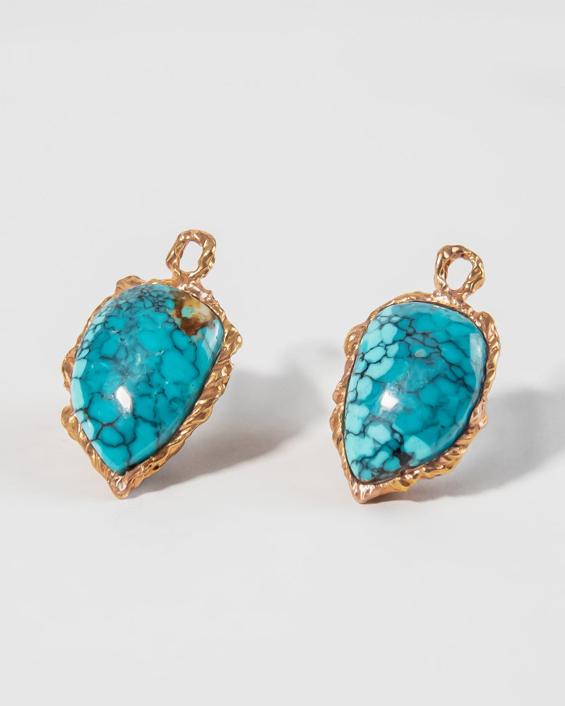 angled view of detachable drops featuring turquoise in an abstract 18K gold setting