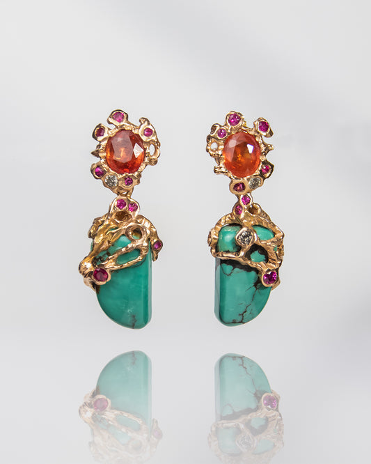 ensemble of sculptural earrings, featuring turquoise, orange sapphire, rubies and diamonds in a sculpted 18K rose gold setting