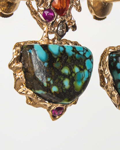 close-up of earrings with a free-form sculpted gold design, capturing the molten texture