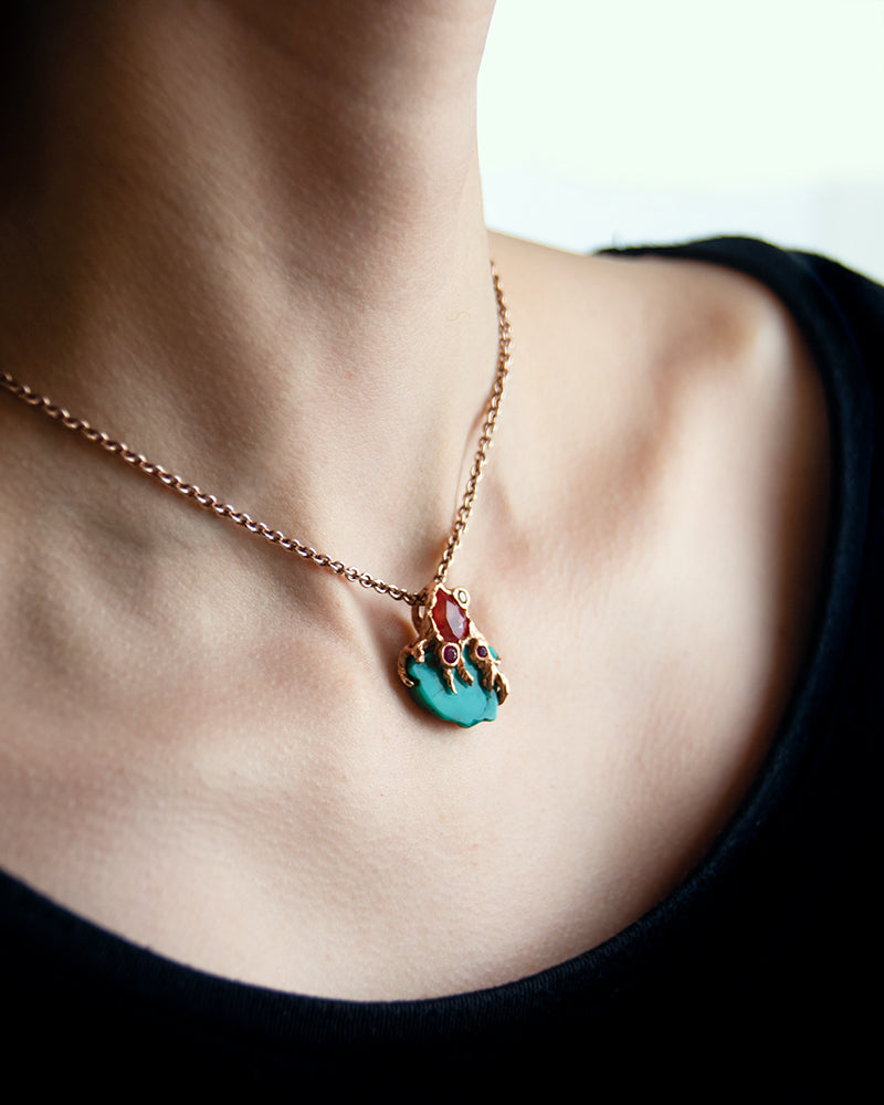 close-up of model wearing an 18K rose gold pendant on a rose gold chain to complement a casual top
