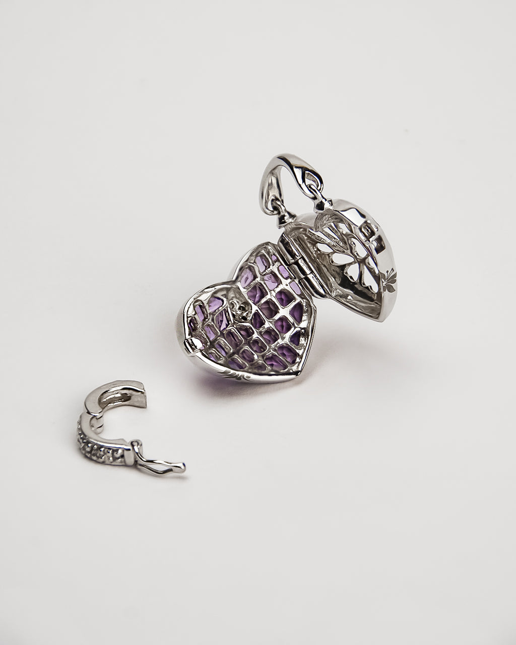 inside a white gold locket, highlighting its intricate detailing and removable clasp to attach the piece to different chains