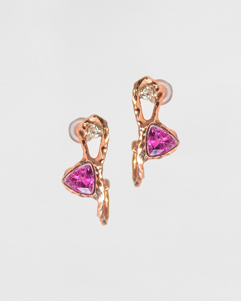 close-up of hoop earrings, featuring an abstract, organic setting that frames trillion-cut pink tourmaline and round faceted diamonds