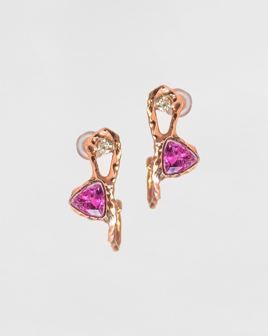 close-up of hoop earrings, featuring an abstract, organic setting that frames trillion-cut pink tourmaline and round faceted diamonds