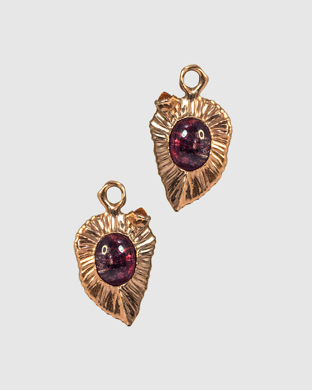 close-up of detachable earring drops with an abstract, free-form setting framed around pink tourmaline and orange sapphire