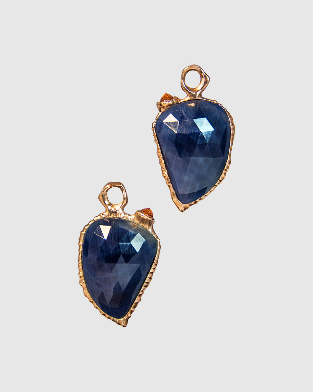 pair of detachable, reversible earring drops featuring blue sapphire and orange sapphire in a free-form rose gold-plated setting