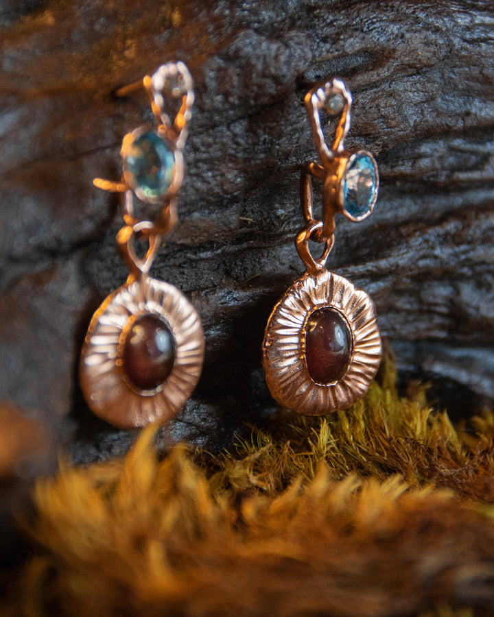 close-up of Nisi Pebble detachable drops paired with hoop earrings, all made from sterling silver plated with 18K rose gold 