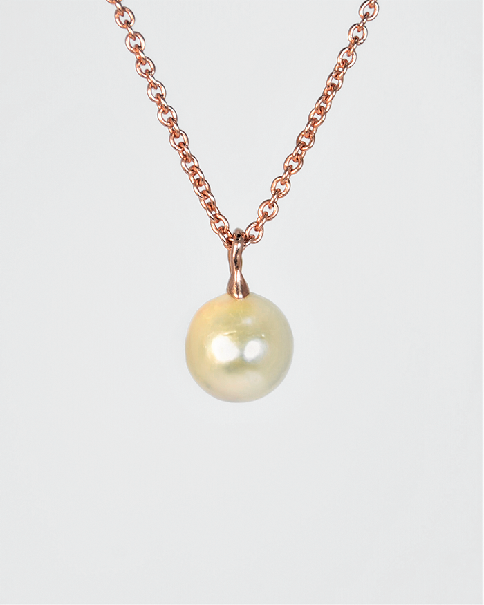 back of a pendant with a free-form gold-plated silver bail holding the pearl in place