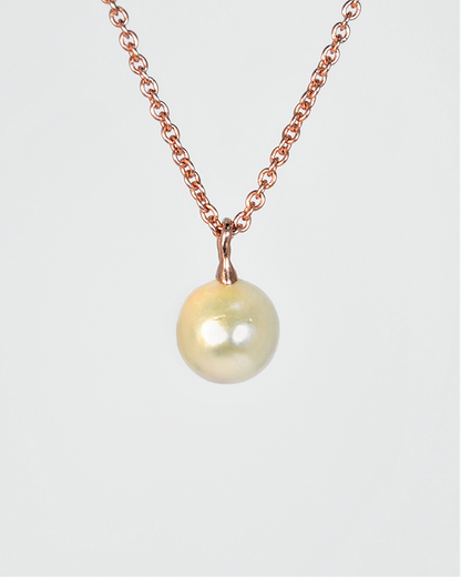 back of a pendant with a free-form gold-plated silver bail holding the pearl in place