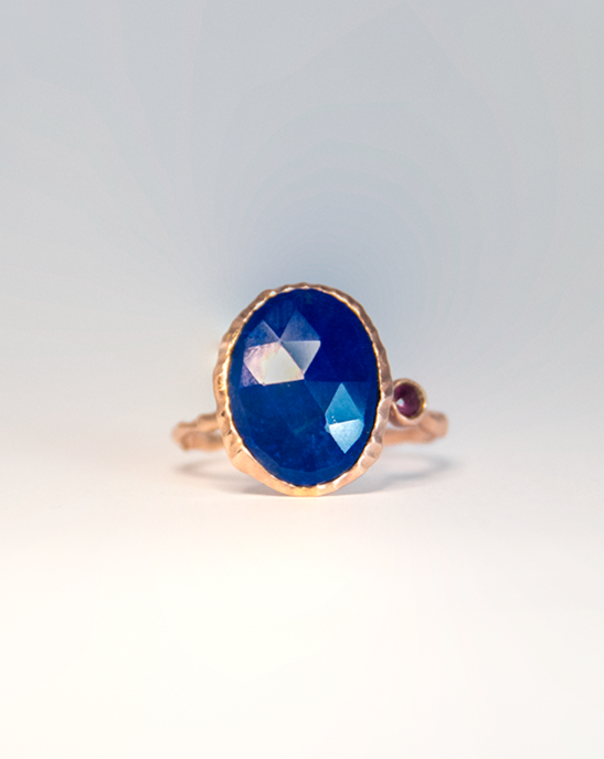 top view of silver ring, emphasising the lapis lazuli centre stone and ruby side stone in a free-form setting