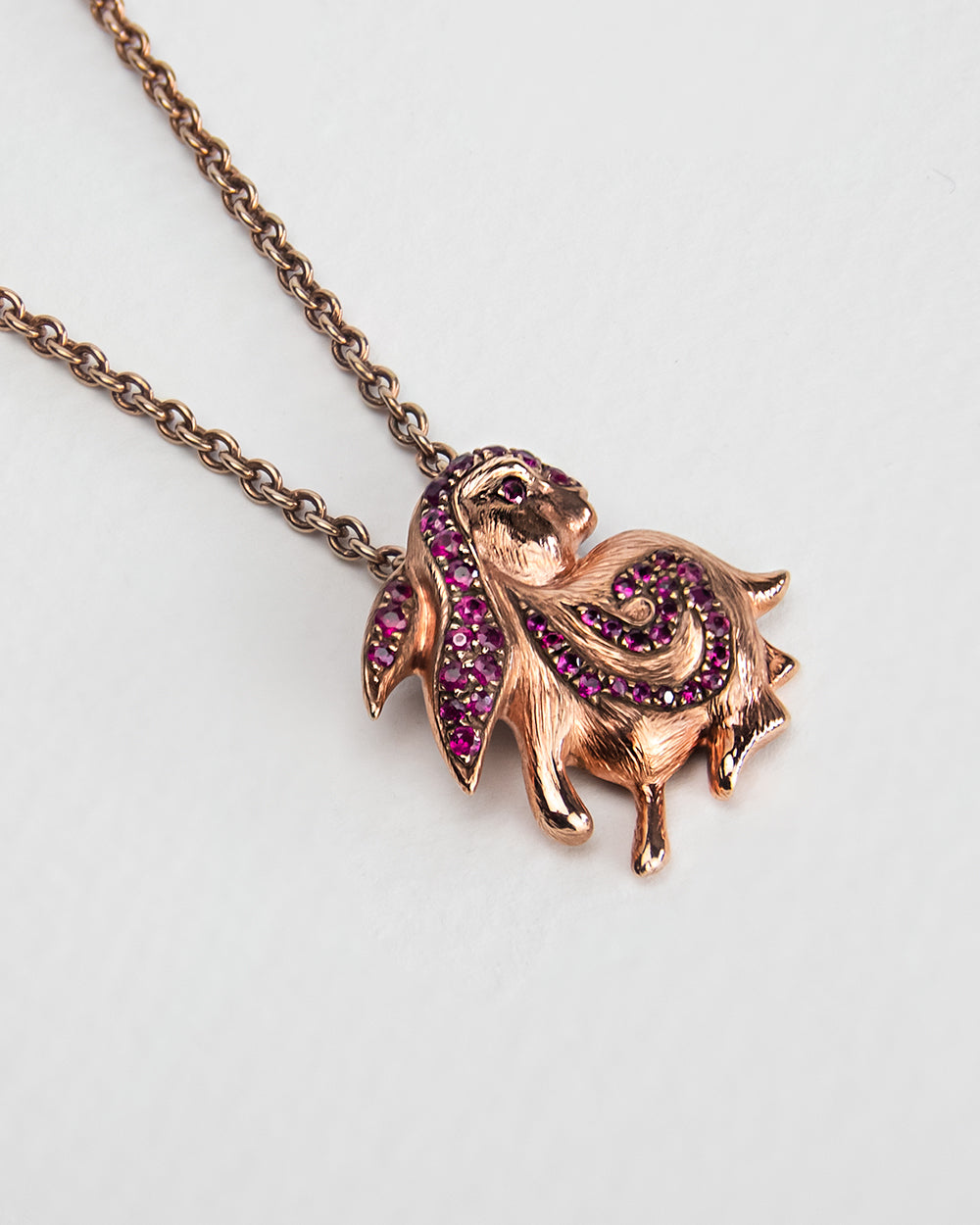 angled view of a rabbit-shaped pendant, highlighting its sculpted details