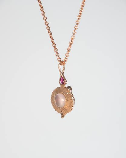 Angle view of Nisi Vessel Pendant in 18K Rose Gold with Rose Quartz, Rubellite, Moonstone and Ruby (reverse side) on 18K Rose Gold Chain