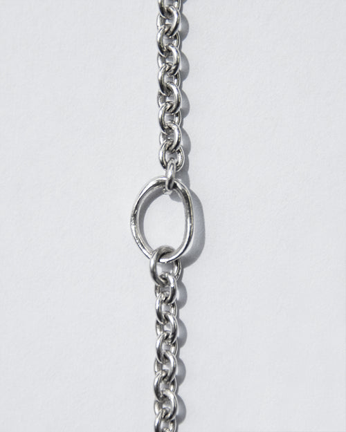close-up of 18-inch white gold chain necklace emphasising its adjuster loop at the 16-inch mark